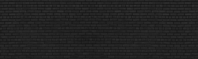 Old black shabby brick wall wide texture. Dark masonry panorama. Brickwork panoramic grunge...