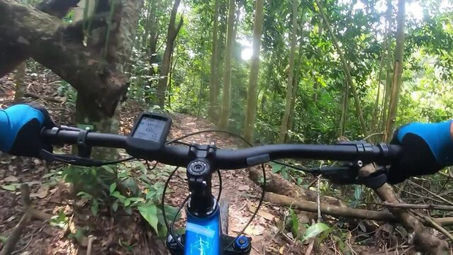 Footage of a man riding a mountain biking on a single track trail also visible a Garmin bike computer. Full HD 60fps footage