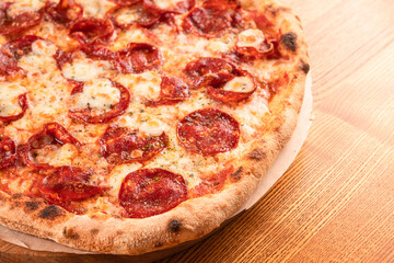 Salami pizza on a wooden table