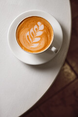 Aroma cappuccino drink on white table