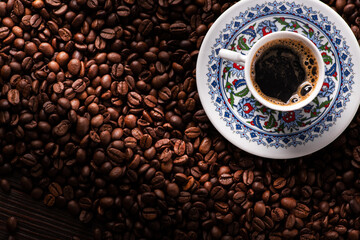 Arabic coffee cup with roasted beans