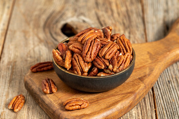 Pecan walnuts on wooden background. close up