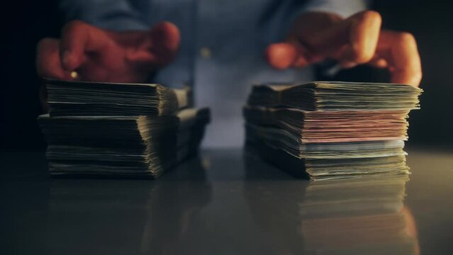 Concept of cash crisis, business, success, debt and finance. Loan in dollars. Person puts a bundle money on the table.