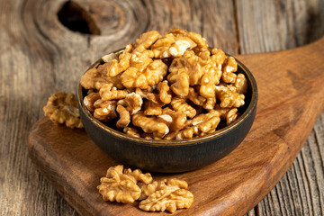 Walnut on wooden background. Close-up walnut kernel