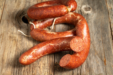 Sausage on a wooden background. Close-up spicy Turkish sausage