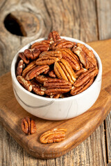 Pecan walnuts on wooden background. close up