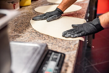 hand of chef baker making pizza at kitchen. The process of making pizza. cooking italian pizza