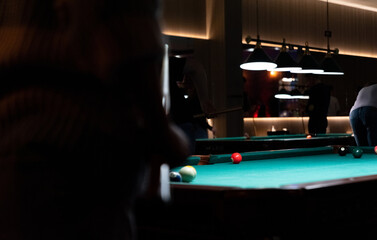 Pool tables for party games. Spending free time. A dark, atmospheric room with pool tables and...
