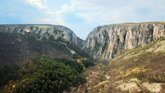 Aerial drone view of a rocky canyon in Romania. Rocky cliffs with sparce vegetation