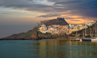 Castelsardo, medieval city on coast of Sardinia, popular travel destination. Sunset in the background. View from marina. Sardinia, Italy