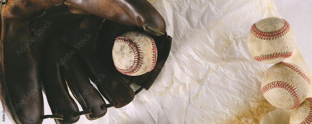 Wall mural vintage baseball glove with flat lay of balls on texture banner background. - Wall murals