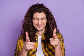 Photo of young handsome guy good mood indicate fingers choose decide isolated over purple color...