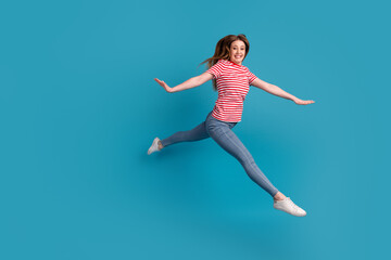 Fototapeta na wymiar Full size profile side photo of young cheerful woman good mood jump up fly isolated over blue color background
