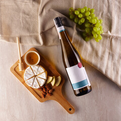 Bottle of wine and tasty food on table with rough cloth