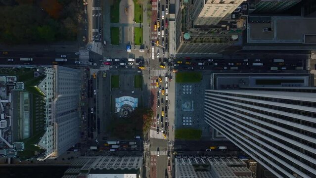 Aerial birds eye overhead top down panning view of busy streets at Pulitzer and Grand Army Plaza. Manhattan, New York City, USA