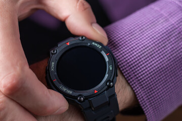 Close up shot of a man hand that uses a smart watch to view incoming messages and calls