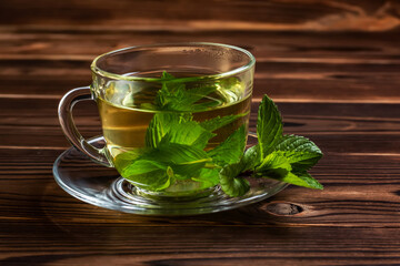 Cup of mint tea and a bunch of mint on the table