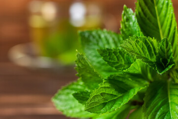 Fresh mint leaves on the background of a cup of tea with mint