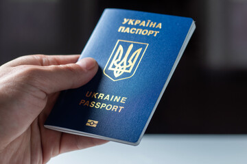 New ukrainian blue biometric passport with identification chip in hands