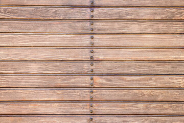 Background of brown wooden slats with screws in the center. - 508066250