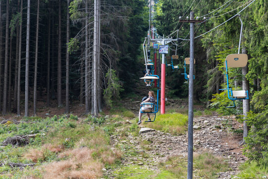 Women riding on the cable car at Mount Klet in Blansky forest in summer. South Bohemian Region, Czech Republic.
