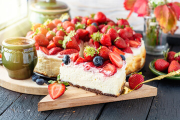 vanilla coconut cheesecake, decorated with fresh strawberries, a cup of aroma coffee on a table	
