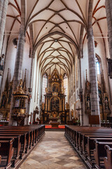 Fototapeta na wymiar Inside St. Vitus church. Interior and altar of St. Vitus cathedral built in gothic style in Cesky Krumlov.