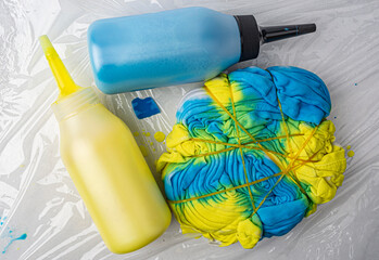 yellow and blue paint bottled on a white background