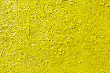 Yellow texture of old cracked paint. The ochre wall is painted with paint. The background of a...