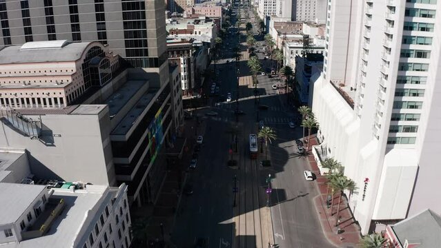 Aerial shot looking down on a streetcar going down Canal Street in downtown New Orleans. 4K