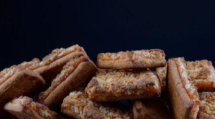 Background of beautiful cookies with orange filling . Square orange cookies .