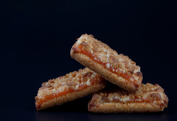 Orange Cookies. Cookies with delicious orange filling on a dark background. close up