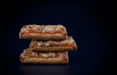 Orange Cookies. Cookies with delicious orange filling on a dark background. close up