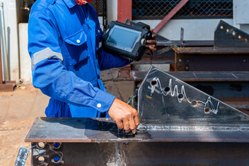 Inspectors are checking defects in welded steel h-beam add joint with process Ultrasonic testing (UT) of Non-Destructive Testing(NDT)