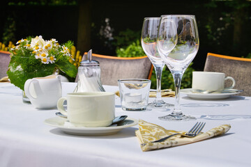 Restaurant or cafe in the garden. Laid table in nature.