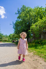 Child girl in the summer in the park. Selective focus.