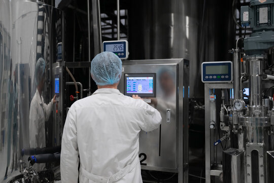 Industrial Engineer Standing In Front Of A Chemical Plant, Producing Organic Fertilizers