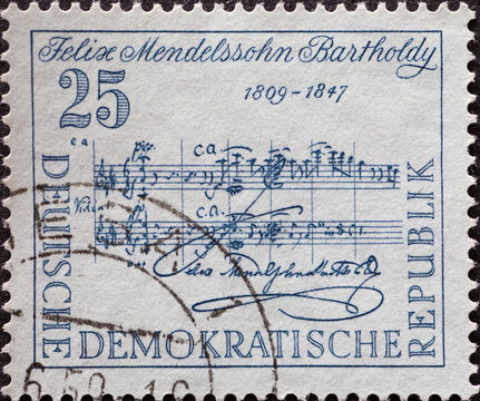 GERMANY, DDR - CIRCA 1959 a postage stamp from GERMANY, DDR, showing a sheet of music from Symphony No. 4 in A major for the 150th birthday of Felix Mendelssohn Bartholdy. Circa 1959