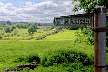 Footpath sign pointing over a traditional hay meadow in Chipping Campden