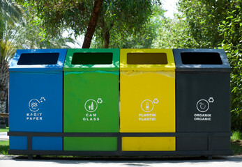 Different colored trash cans with inscriptions paper, plastic, glass and organic waste suitable for...