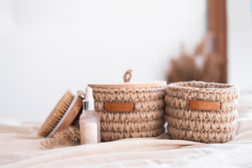 Fototapeta na wymiar woven jute basket with natural body care products with body brush in bathroom near mirror. Beige interior Natural hygiene products. Zero waste concept.