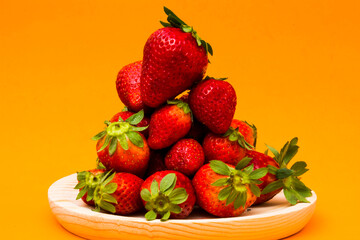 Fresh strawberries on orange background