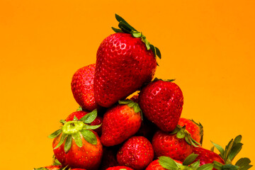 Fresh strawberries on orange background