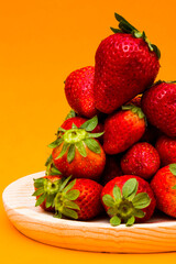 Fresh strawberries on orange background