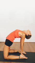 Mid-age woman practicing yoga in a yoga studio