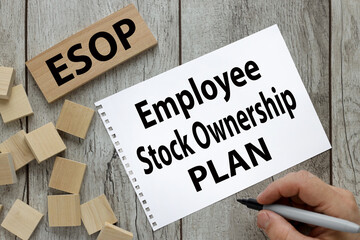 ESOP - notepad with text on a wooden table. text on wood block