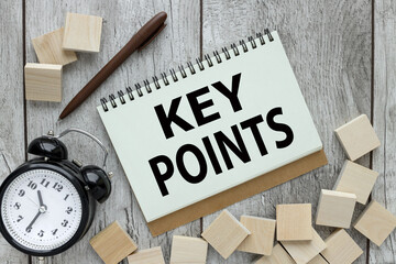 KEY POINTS. text on a notepad page. next to the table clock