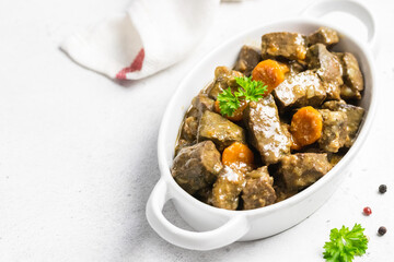 Beef carrot spiced liver in ceramic dish. Copy space.