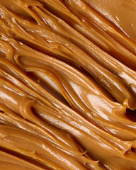 Caramel texture created with spatula on a white background