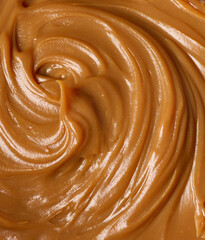 Caramel texture created with spatula on a white background